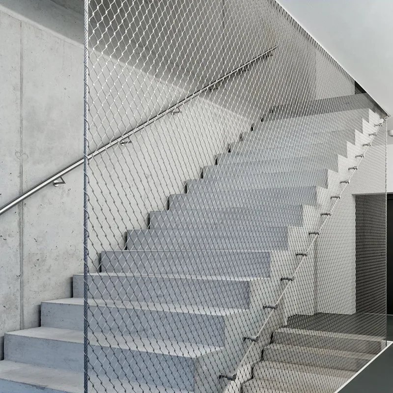 Architectural mesh installed along a modern stair